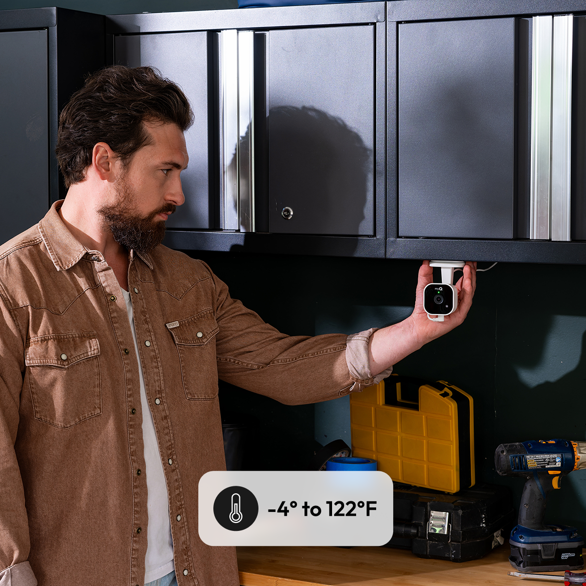 Man installing camera under cabinet